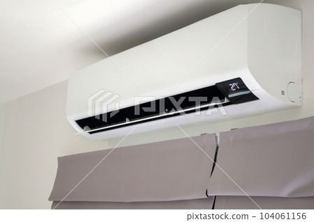 Air conditioner on white wall room interior background Air conditioner on white wall room interior background 104061156