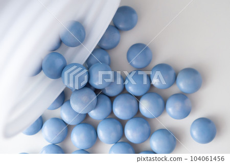 blue medicine pills with bottle on white background 104061456
