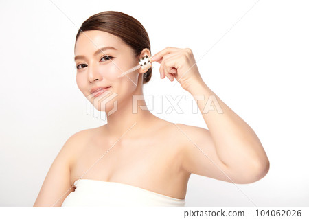 Beautiful young asian woman apply facial serum on white background, Skin care and rejuvenation, Face care, Facial treatment, Cosmetology, beauty, 104062026