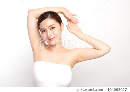 Beautiful Young Asian woman lifting hands up to show off clean and hygienic armpits or underarms on white background, Smooth armpit cleanliness and protection concept 104062027