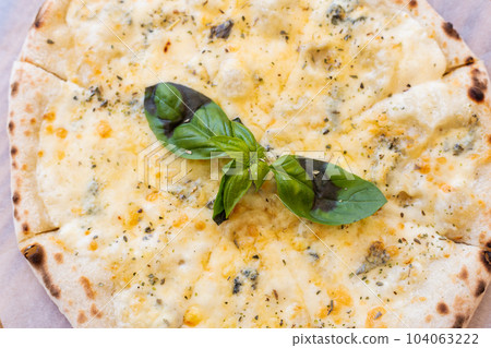 Fragrant Italian pizza of four cheeses - parmesan, dor blue, mozzarella, cheddar, Close up, top view. Fragrant Italian pizza of four cheeses - parmesan, dor blue, mozzarella, cheddar, Close up, top view. 104063222