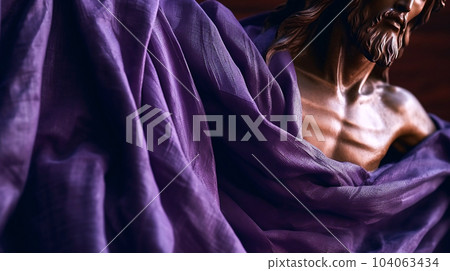 Status of Jesus Christ covered with purple shawl. Lent season, Holy week and Good friday concept 104063434