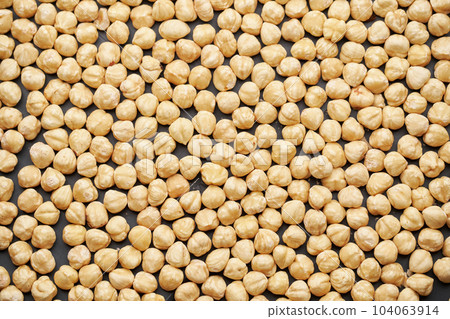 Whole shelled hazelnuts nuts kernels close-up studio background 104063914
