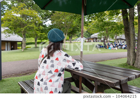 A tourist woman relaxing on a bench at Roadside Station Den-en Plaza 104064215