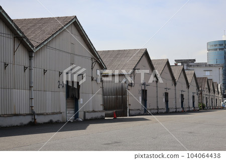 Landscape of a townscape with blue sky, clouds and many warehouse buildings Landscape of a townscape with blue sky, clouds and many warehouse buildings 104064438