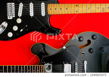 Electric Guitar on a red background. Electric Guitar on a red background. 104065075