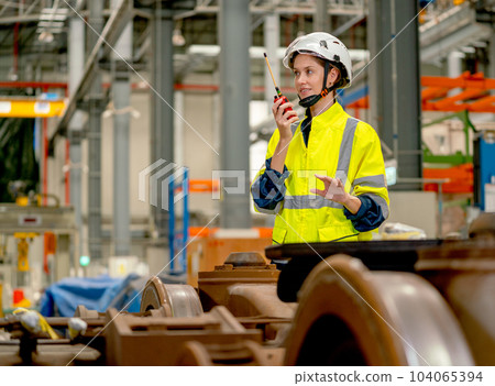 Profession engineer or technician worker use walkie talkie to contact with co-worker or team staff Profession engineer or technician worker use walkie talkie to contact with co-worker or team staff 104065394