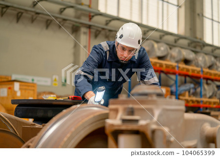 Professional technician or engineer worker hold light stick to check and fix problem of part train 104065399