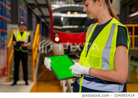 Close up engineer or technician worker woman hold tablet with green screen and look at it 104065414