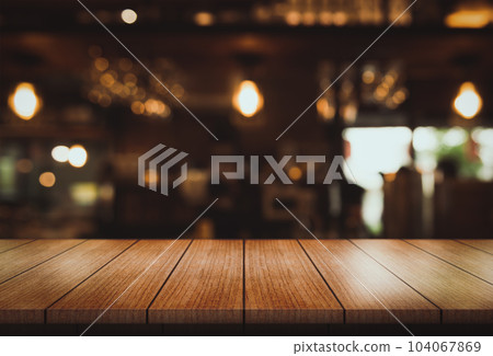 Empty wooden table top with lights bokeh on blur restaurant background. 104067869
