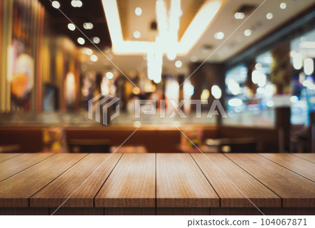Empty wooden table top with lights bokeh on blur restaurant background. Empty wooden table top with lights bokeh on blur restaurant background. 104067871