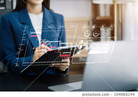 Business woman hand Project manager working and update tasks and Gantt chart scheduling virtual diagram.with smart phone, tablet and laptop in office. 104068144