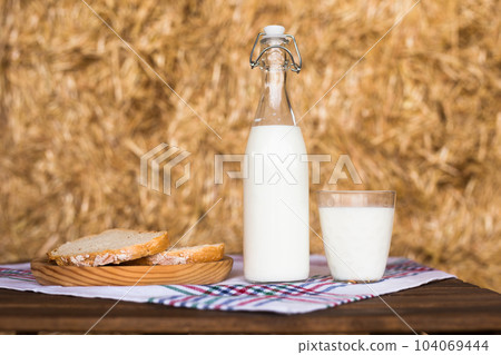 Rustic breakfast of milk, fresh wheat bread and butter in the haylof 104069444