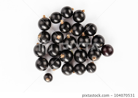 Ripe blackcurrant berries are scattered, isolated on a white background. Ripe blackcurrant berries are scattered, isolated on a white background. 104070531