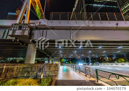 The cityscape of Tokyo, Japan, overlooking Kamakura Bridge at night. The Tokyo Metro Marunouchi Line runs underground. The back of the bridge is on the Otemachi side The cityscape of Tokyo, Japan, overlooking Kamakura Bridge at night. The Tokyo Metro Marunouchi Line runs underground. The back of the bridge is on the Otemachi side 104070579
