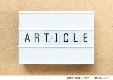 Lightbox with word article on wood background 104070752