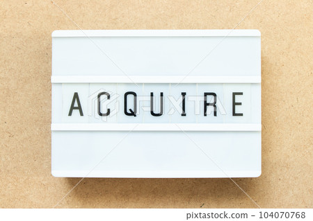 Lightbox with word acquire on wood background Lightbox with word acquire on wood background 104070768