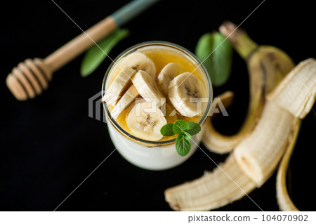 Sweet homemade yogurt with bananas and honey Sweet homemade yogurt with bananas and honey 104070902