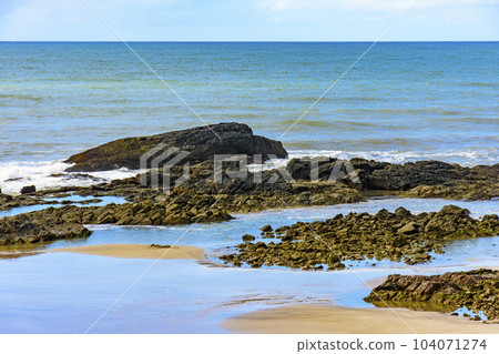 Sand between the rocks and the sea at Prainha beach 104071274