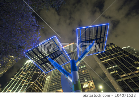 Downtown district of Miami city with photovoltaic panels mounted on metal poles for electricity supply of street illumination and surveillance cameras. Futuristic energy source in modern megapolis Downtown district of Miami city with photovoltaic panels mounted on metal poles for electricity supply of street illumination and surveillance cameras. Futuristic energy source in modern megapolis 104071528