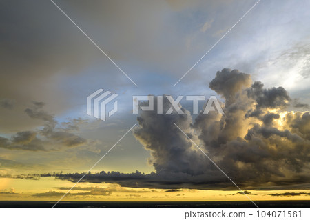 Colorful evening landscape with soft pastel coloured clouds on watercolor tinted sunset sky. Abstract nature background 104071581