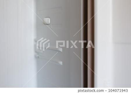 An empty white refrigerator with open doors reveals its shelves, showcasing its spacious interior. Out of focus 104071943
