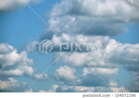 Bright landscape of white puffy cumulus clouds on blue clear sky. 104072286