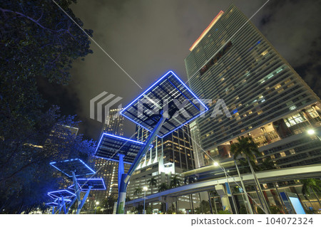 Blue solar photovoltaic panels mounted in modern city on street poles for electricity supply of streetlights and surveillance cameras. Futuristic energy source in downtown Miami, Florida Blue solar photovoltaic panels mounted in modern city on street poles for electricity supply of streetlights and surveillance cameras. Futuristic energy source in downtown Miami, Florida 104072324