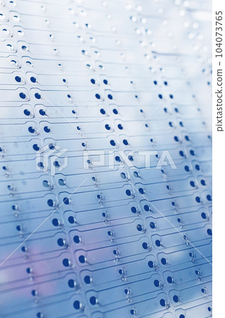 Industrial background. A metal sheet cut into a pattern for assembling stainless steel metal cabinets. Toned image Industrial background. A metal sheet cut into a pattern for assembling stainless steel metal cabinets. Toned image 104073765