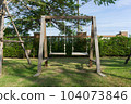 Wooden swing on the green grass in the garden, Thailand. 104073846