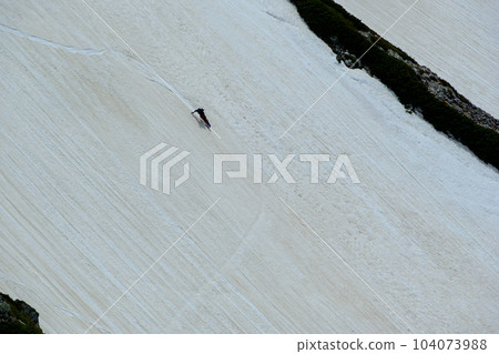 A snowboarder gliding down Kenzawa 104073988
