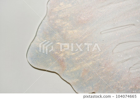 Beauty gel texture with pink and golden particles. Shining highlighter background with brush strokes 104074665