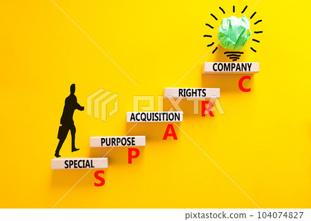 SPARC special purpose acquisition company symbol. Concept words SPARC special purpose acquisition company on wooden block. Yellow background. Business SPARC special purpose acquisition company concept 104074827