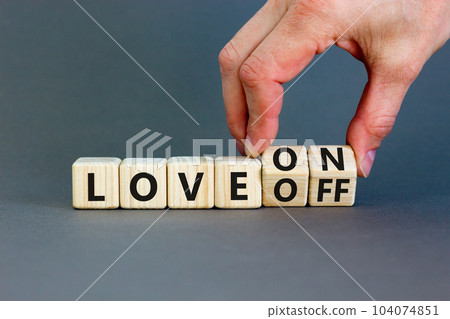 Love on or off symbol. Businessman turns wooden cubes and changes word Love off to Love on. Beautiful grey table grey background. Business and love on or off concept. Copy space. 104074851
