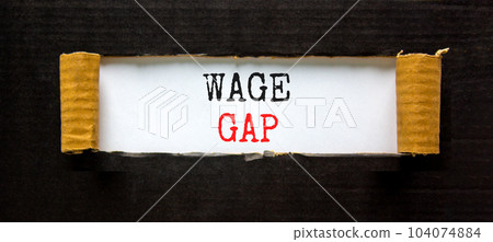 Wage gap symbol. Concept words Wage gap on beautiful white paper on a beautiful black background. Business, support and wage gap concept. Copy space. Wage gap symbol. Concept words Wage gap on beautiful white paper on a beautiful black background. Business, support and wage gap concept. Copy space. 104074884