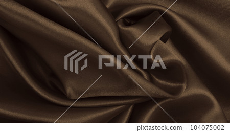 Smooth elegant brown silk or satin luxury cloth texture as abstract background. Luxurious background design wallpaper. In Sepia toned. Retro style Smooth elegant brown silk or satin luxury cloth texture as abstract background. Luxurious background design wallpaper. In Sepia toned. Retro style 104075002
