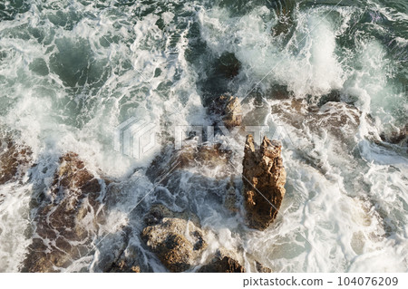 Fresnch Riviera cliffs with sea waves crushing on them 104076209