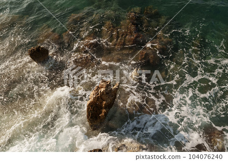 Fresnch Riviera cliffs with sea waves crushing on them 104076240