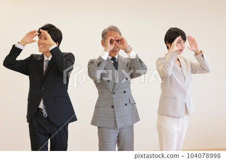 三名商務人士用雙筒望遠鏡朝不同的方向看遠_1 104078998