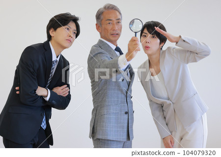 The president and two subordinates looking for career paths with a magnifying glass_1 The president and two subordinates looking for career paths with a magnifying glass_1 104079320