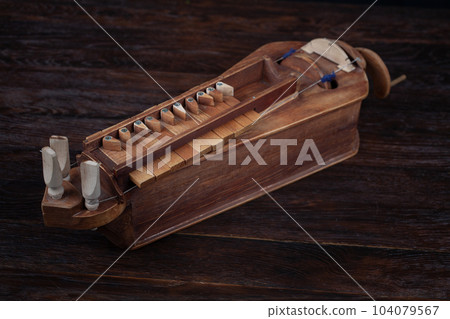 The Hurdy-gurdy, stringed musical instrument. 104079567