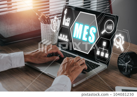 MES, Manufacturing Execution System concept, Businessman working on laptop with Manufacturing Execution System icon on virtual screen. 104081230