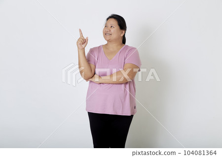 Beautiful Asian plus-size woman smiles with positive emotion, feeling happy and proud of her body overweight. Portrait shot on white background with copy space. 104081364