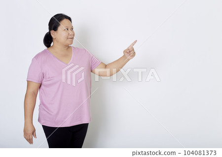 Beautiful Asian plus-size woman smiles with positive emotion, feeling happy and proud of her body overweight. Portrait shot on white background with copy space. 104081373