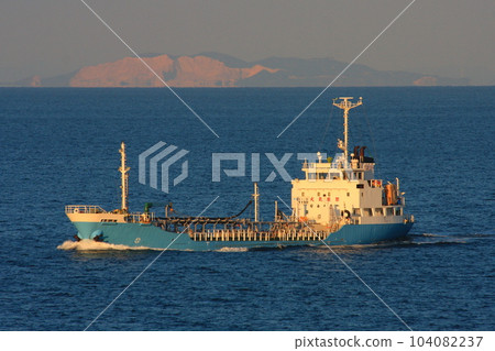 A small chemical tanker navigating the Seto Inland Sea at dusk (Ogashima, one of the Ieshima Islands, in the background) 104082237