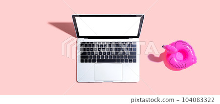 Laptop computer with a pink flamingo Laptop computer with a pink flamingo 104083322