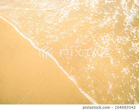 Lite yellow sand of beach and soft wave background 104083542
