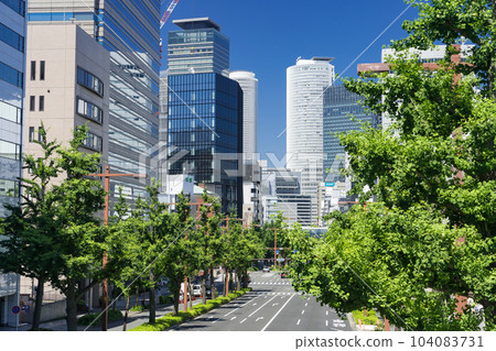 Nagoya Naka Ward Urban landscape Sakura-dori ginkgo trees and Nagoya station buildings Newtas from the Marunouchi pedestrian bridge 104083731