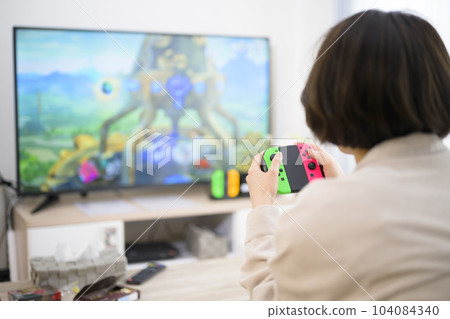 young woman playing video games 104084340