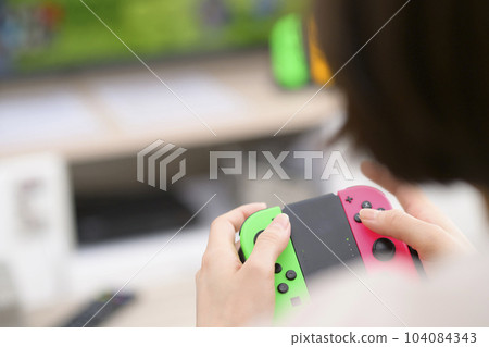 young woman playing video games 104084343